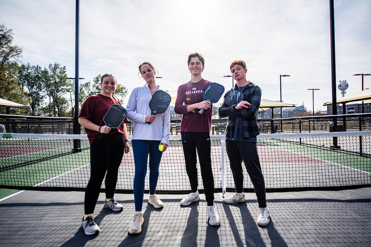 Students play pickleball on the courts outside Sanderson Center