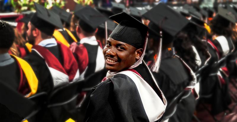 A grad student looks at the camera during the ceremony